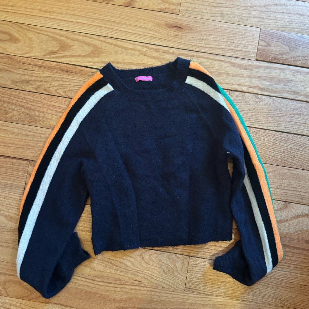 cropped blue sweater with colorful panels on the sleeve